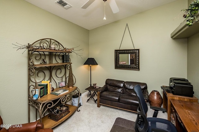 carpeted office space with visible vents and a ceiling fan