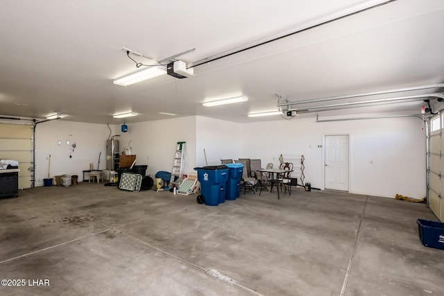 garage with gas water heater and a garage door opener