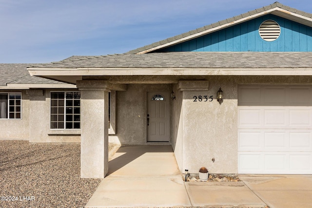 view of exterior entry featuring a garage