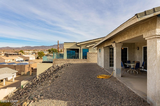 view of yard featuring a mountain view and a patio