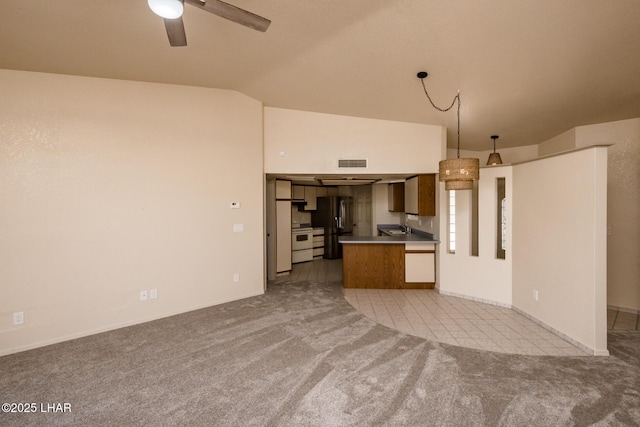 kitchen with ceiling fan, vaulted ceiling, stainless steel refrigerator with ice dispenser, light carpet, and open floor plan