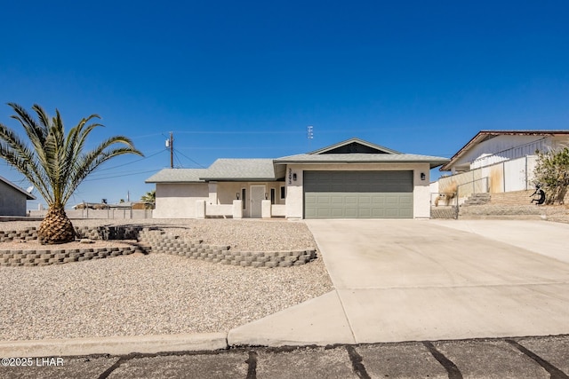 ranch-style home with stucco siding, concrete driveway, and an attached garage