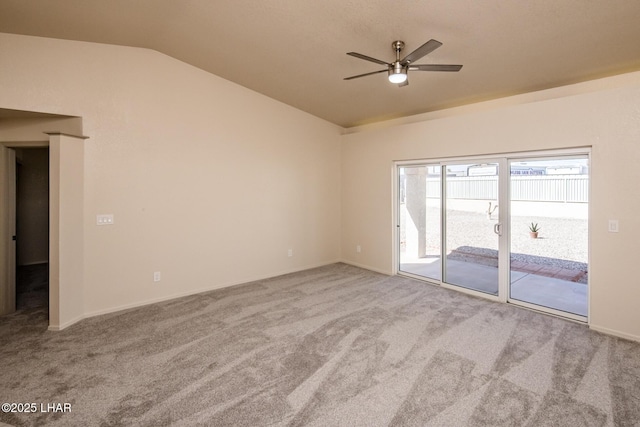 empty room featuring carpet flooring, ceiling fan, and vaulted ceiling