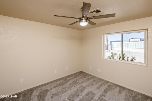 empty room featuring visible vents, ceiling fan, baseboards, and carpet