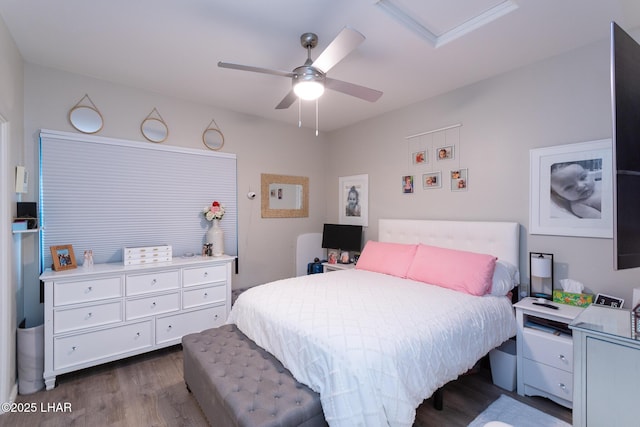 bedroom with dark wood-style floors, attic access, and ceiling fan