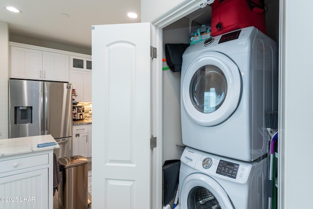 laundry room featuring stacked washer / dryer and laundry area