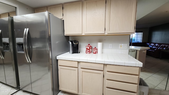 2095 Mesquite Ave Unit 27, Lake Havasu City, AZ 86403 - kitchen with stainless steel refrigerator with ice dispenser, light tile patterned flooring, light brown cabinets, and tile countertops