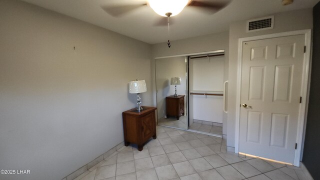 2095 Mesquite Ave Unit 27, Lake Havasu City, AZ 86403 - unfurnished bedroom featuring a closet, light tile patterned floors, and a ceiling fan