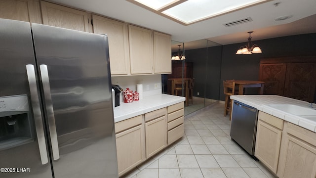 2095 Mesquite Ave Unit 27, Lake Havasu City, AZ 86403 - kitchen featuring appliances with stainless steel finishes, tile counters, a chandelier, light brown cabinetry, and light tile patterned floors