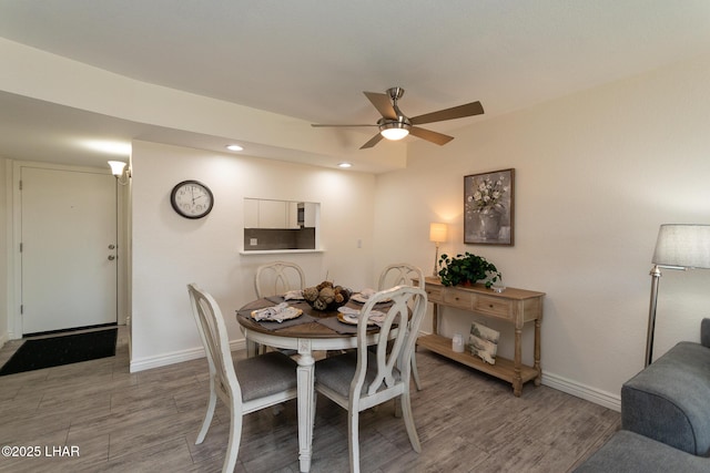 dining space with baseboards, a ceiling fan, recessed lighting, and wood finished floors