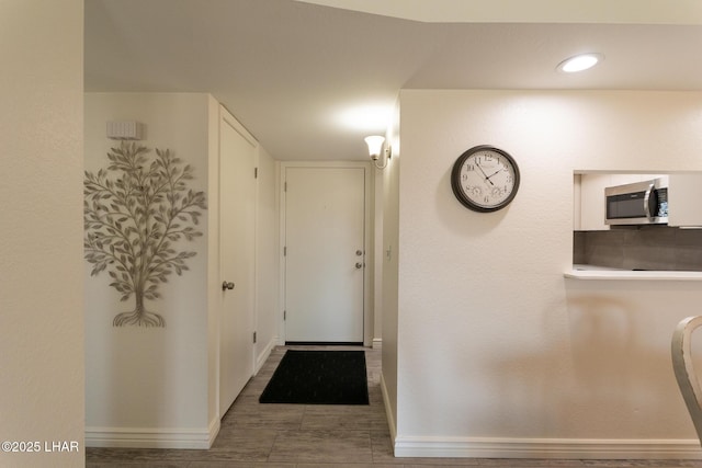 hall featuring baseboards