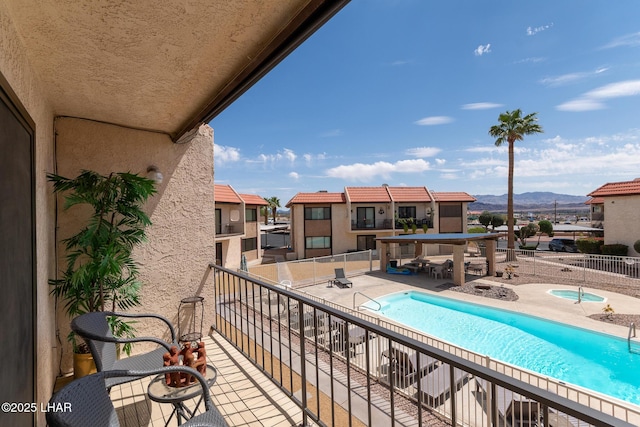 balcony featuring a community hot tub and a mountain view