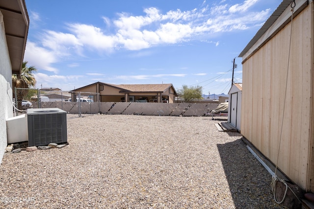 view of yard featuring central AC and a fenced backyard