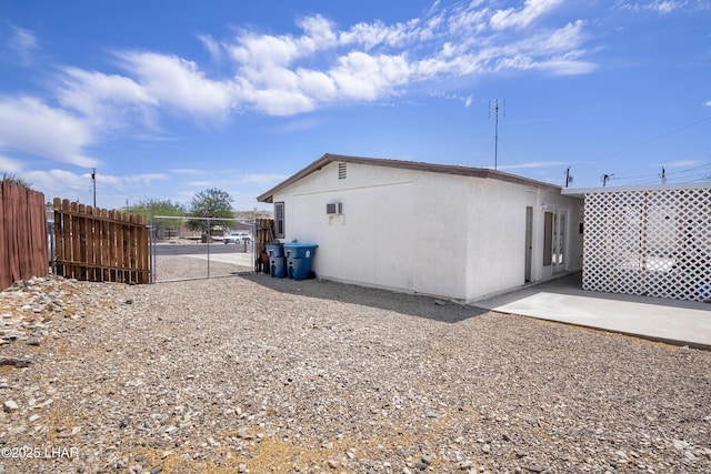 rear view of house with a gate and fence