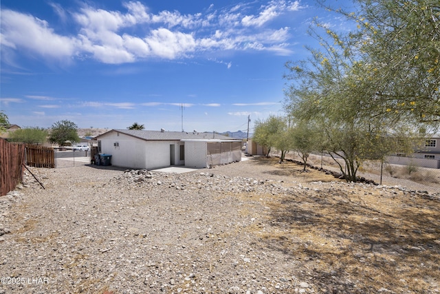 rear view of property featuring fence