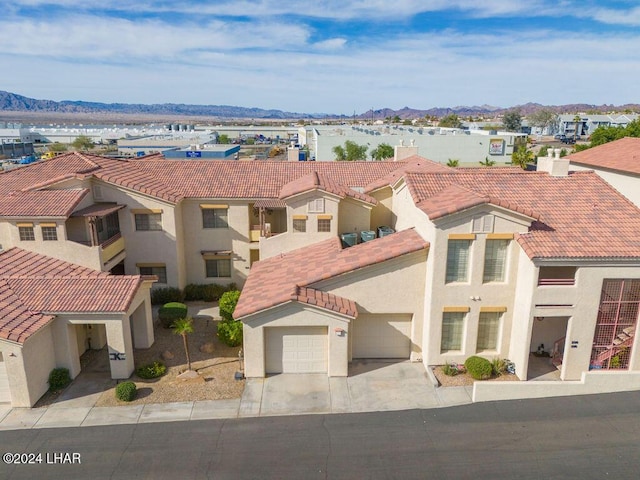 birds eye view of property with a mountain view