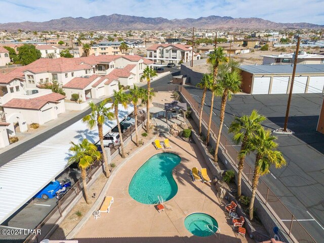 view of swimming pool with a mountain view and a patio area