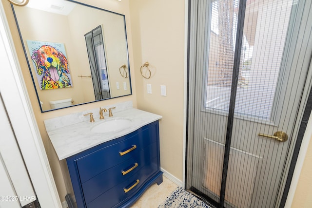 bathroom featuring baseboards, vanity, and tile patterned floors