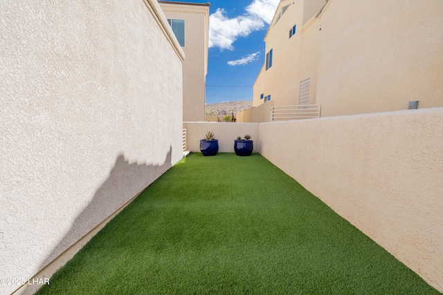 view of yard featuring a balcony