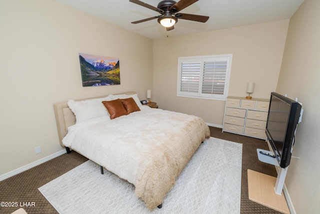 bedroom with dark colored carpet, a ceiling fan, and baseboards