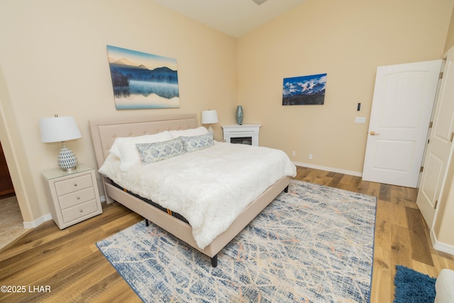 bedroom with light wood-style flooring and baseboards