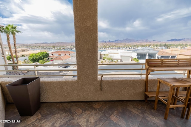 balcony featuring a residential view and a mountain view