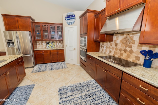 kitchen featuring decorative backsplash, glass insert cabinets, appliances with stainless steel finishes, under cabinet range hood, and light tile patterned flooring