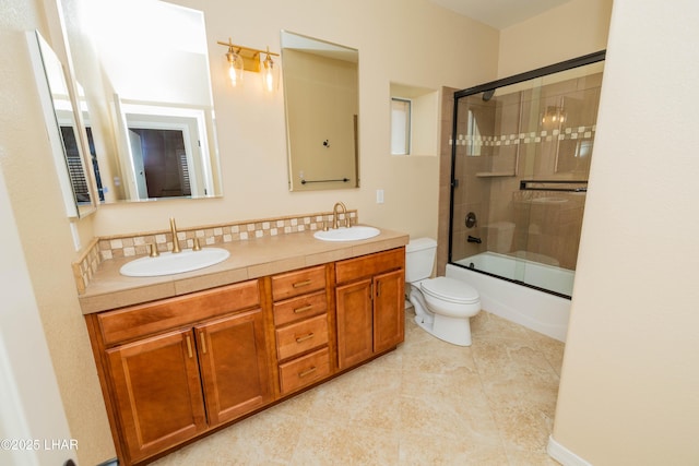 bathroom featuring enclosed tub / shower combo, a sink, toilet, and double vanity