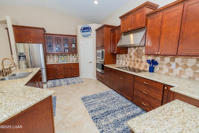 kitchen featuring light tile patterned floors, appliances with stainless steel finishes, vaulted ceiling, under cabinet range hood, and a sink