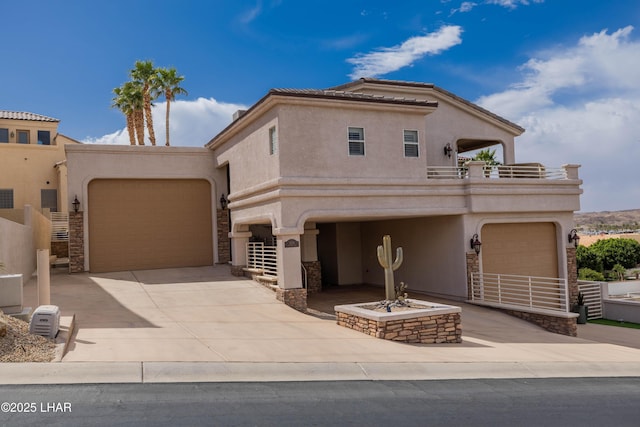 view of front of home with stucco siding, concrete driveway, a balcony, a garage, and stone siding