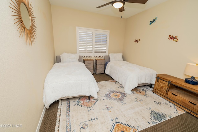 bedroom with ceiling fan and baseboards