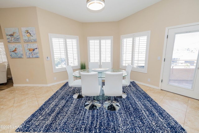 dining space featuring baseboards, plenty of natural light, and tile patterned floors