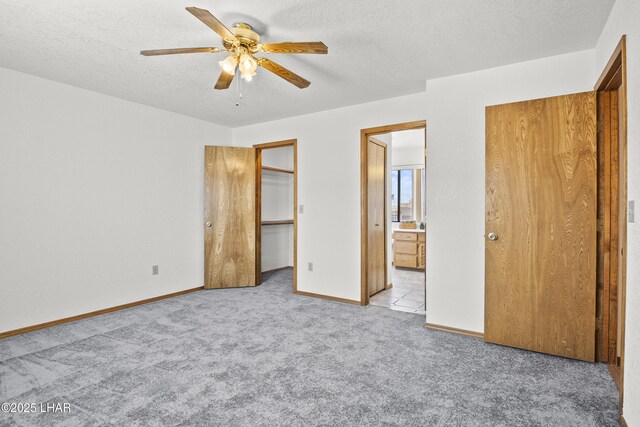 bathroom with vanity, a shower with shower door, toilet, and plenty of natural light