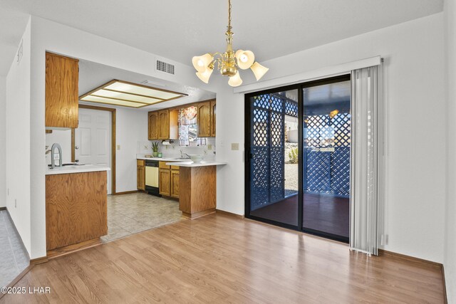 kitchen featuring sink, a kitchen breakfast bar, dishwasher, kitchen peninsula, and electric stove