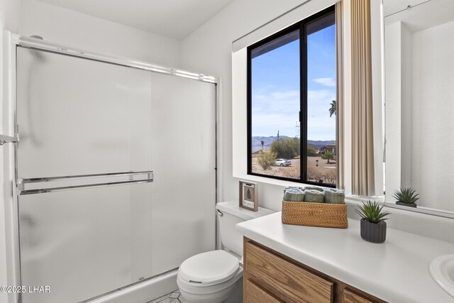 full bathroom featuring vanity, enclosed tub / shower combo, and toilet