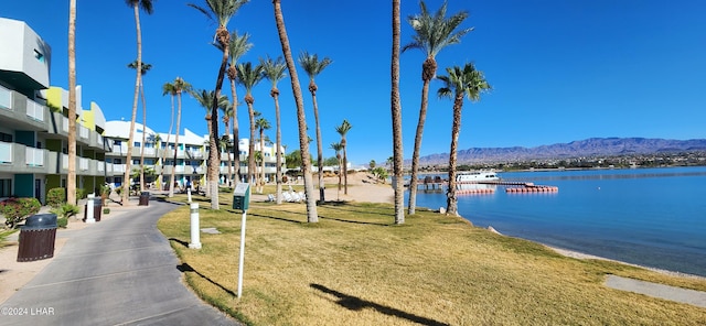 view of community featuring a yard and a water and mountain view