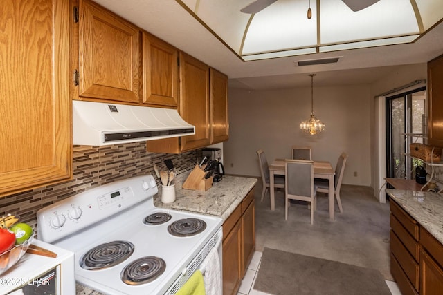kitchen featuring visible vents, brown cabinets, tasteful backsplash, electric stove, and exhaust hood