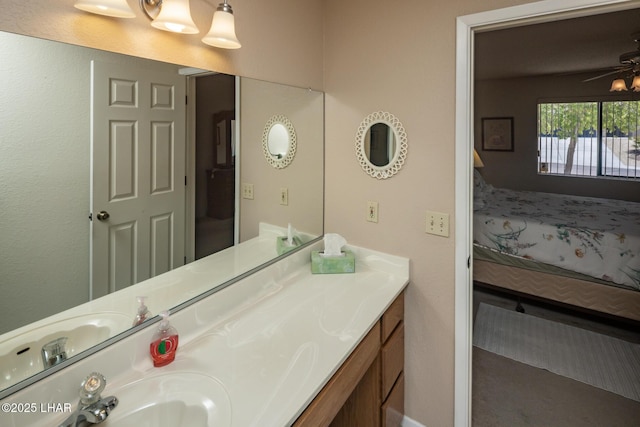 bathroom with vanity, a ceiling fan, and connected bathroom