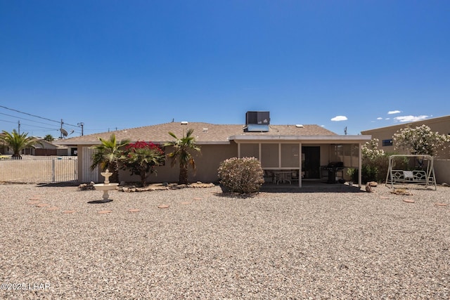 back of property featuring fence, central AC, and a patio area