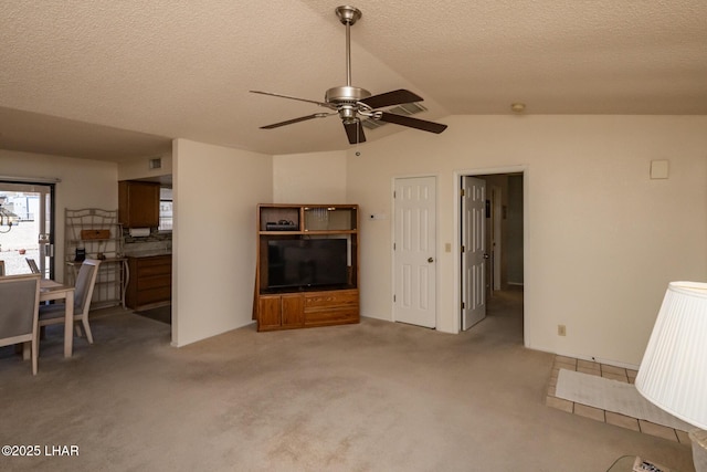 living room with a textured ceiling, ceiling fan, light colored carpet, and lofted ceiling