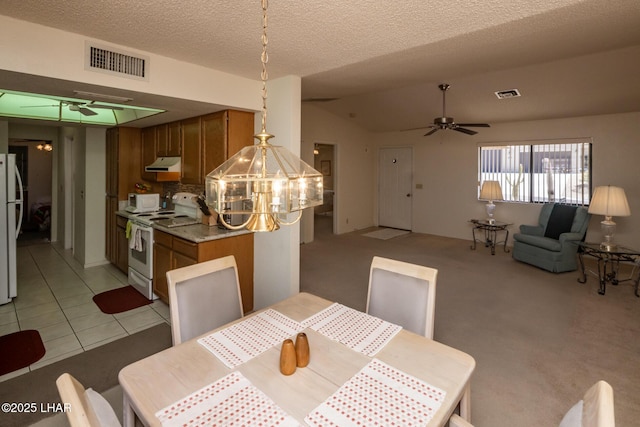 dining space with visible vents, a textured ceiling, ceiling fan with notable chandelier, and lofted ceiling
