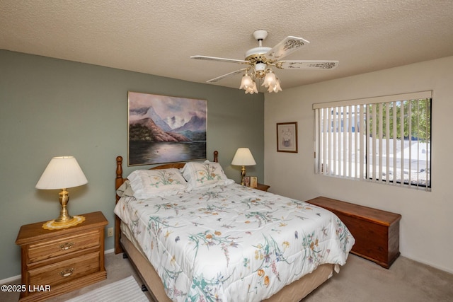 carpeted bedroom with baseboards, a textured ceiling, and ceiling fan