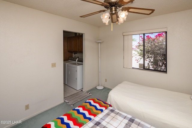carpeted bedroom with baseboards, ceiling fan, and washing machine and clothes dryer