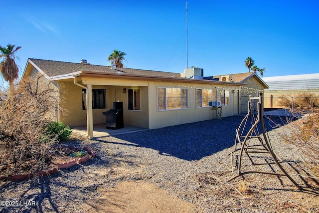 back of house with a patio