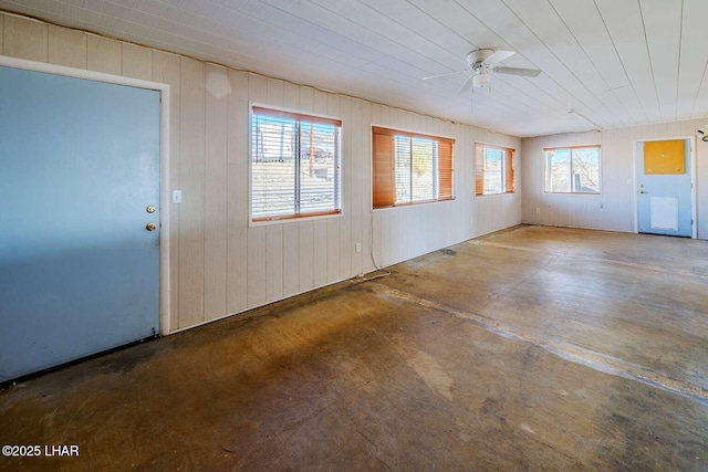 unfurnished sunroom with ceiling fan