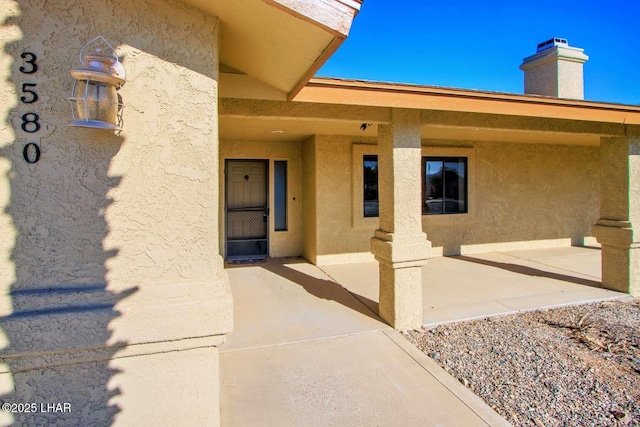 property entrance featuring a patio area