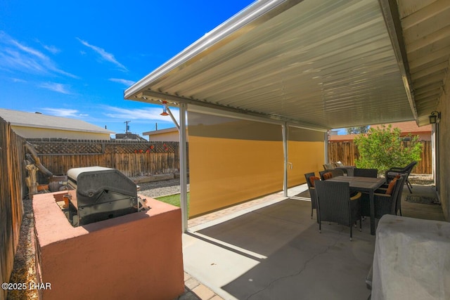 view of patio with outdoor dining space, area for grilling, and a fenced backyard