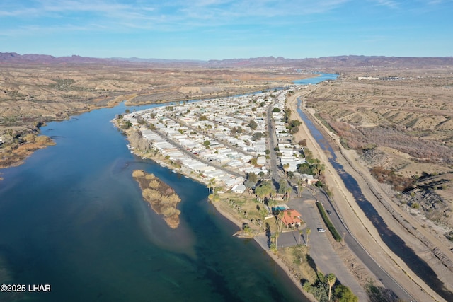 drone / aerial view featuring a water and mountain view