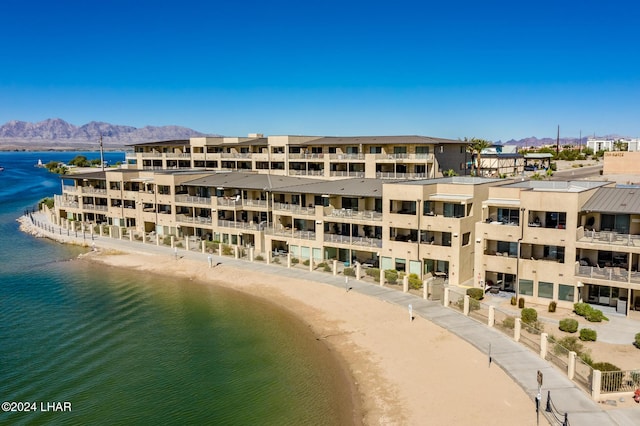 view of property featuring a beach view and a water and mountain view