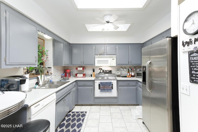 kitchen featuring gray cabinetry, sink, white appliances, and ceiling fan